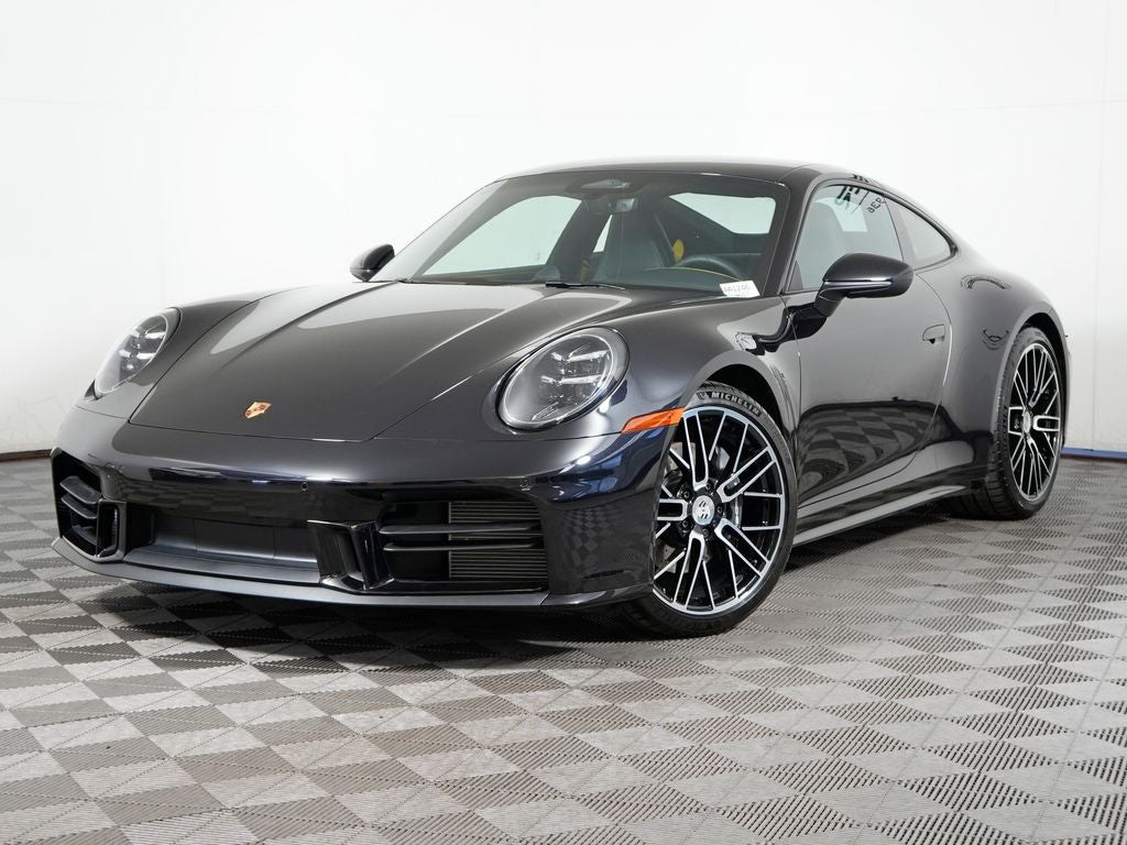 2026 Porsche 911 Carrera in Jet Black Metallic — front three-quarter view